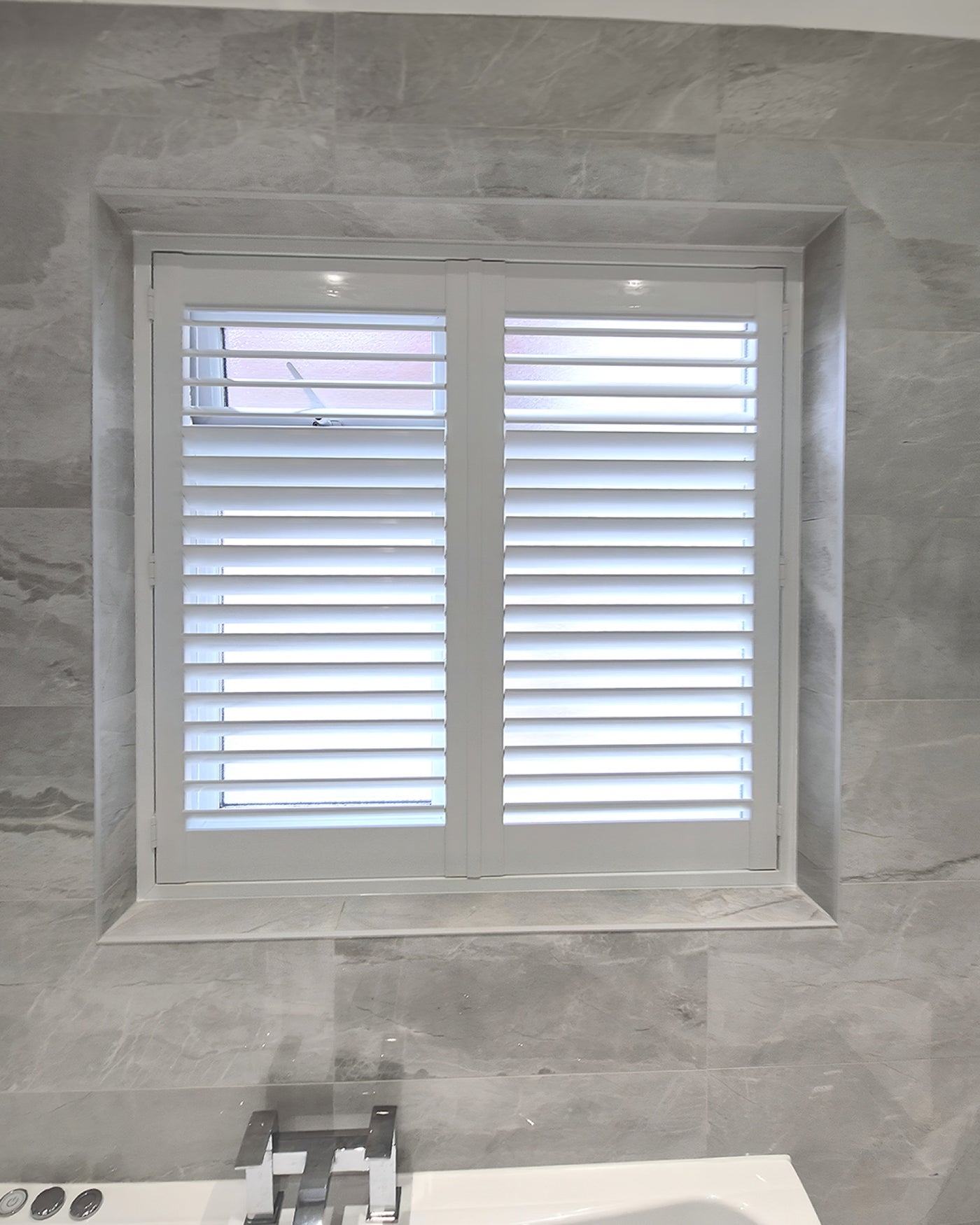 Classic collection shutters in a marble bathroom