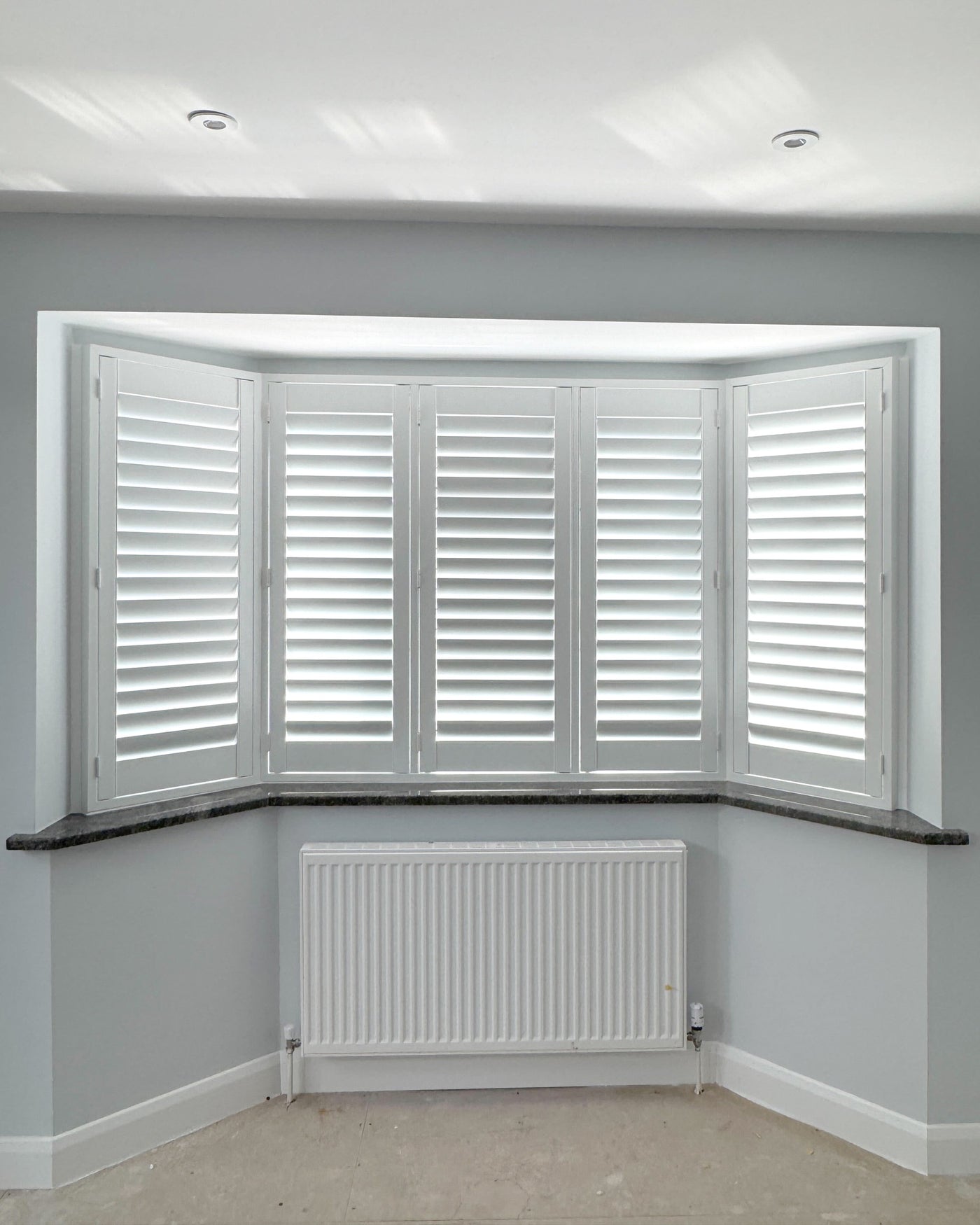 Classic collection shutters on a bay window in a living room