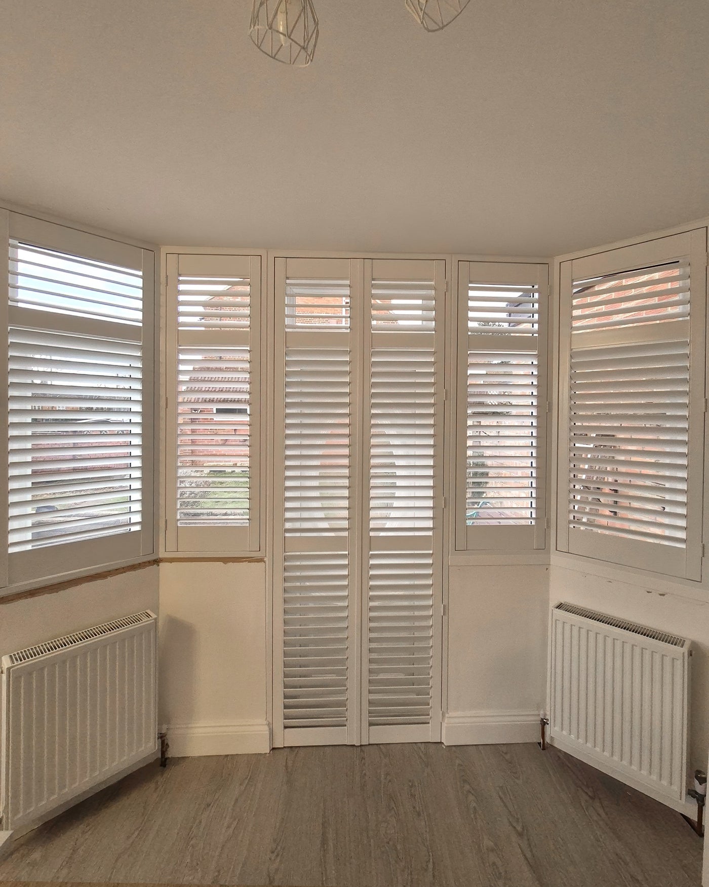 Linea collection shutters on a wide bay window