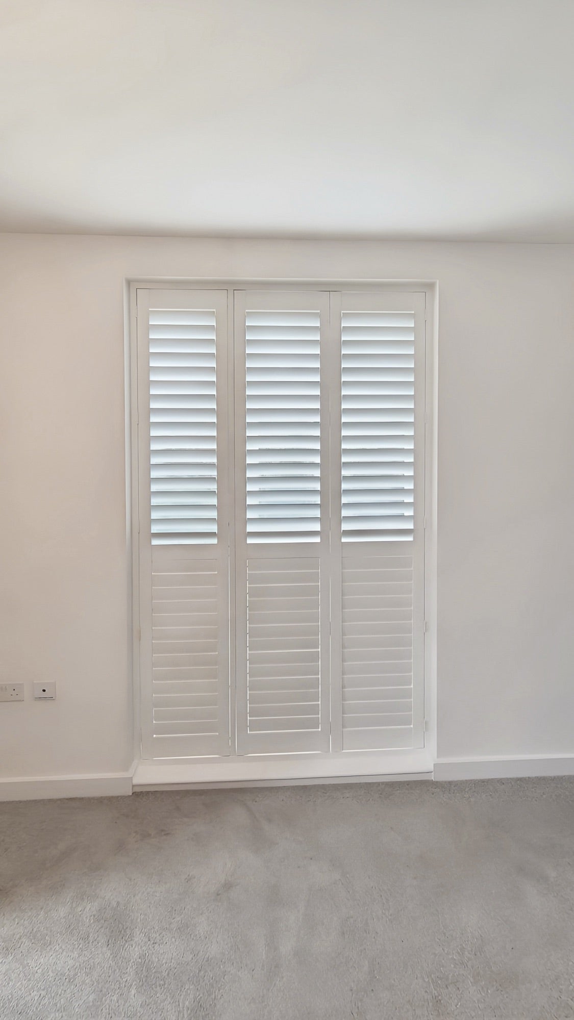 Linea collection shutters on a corner bay window