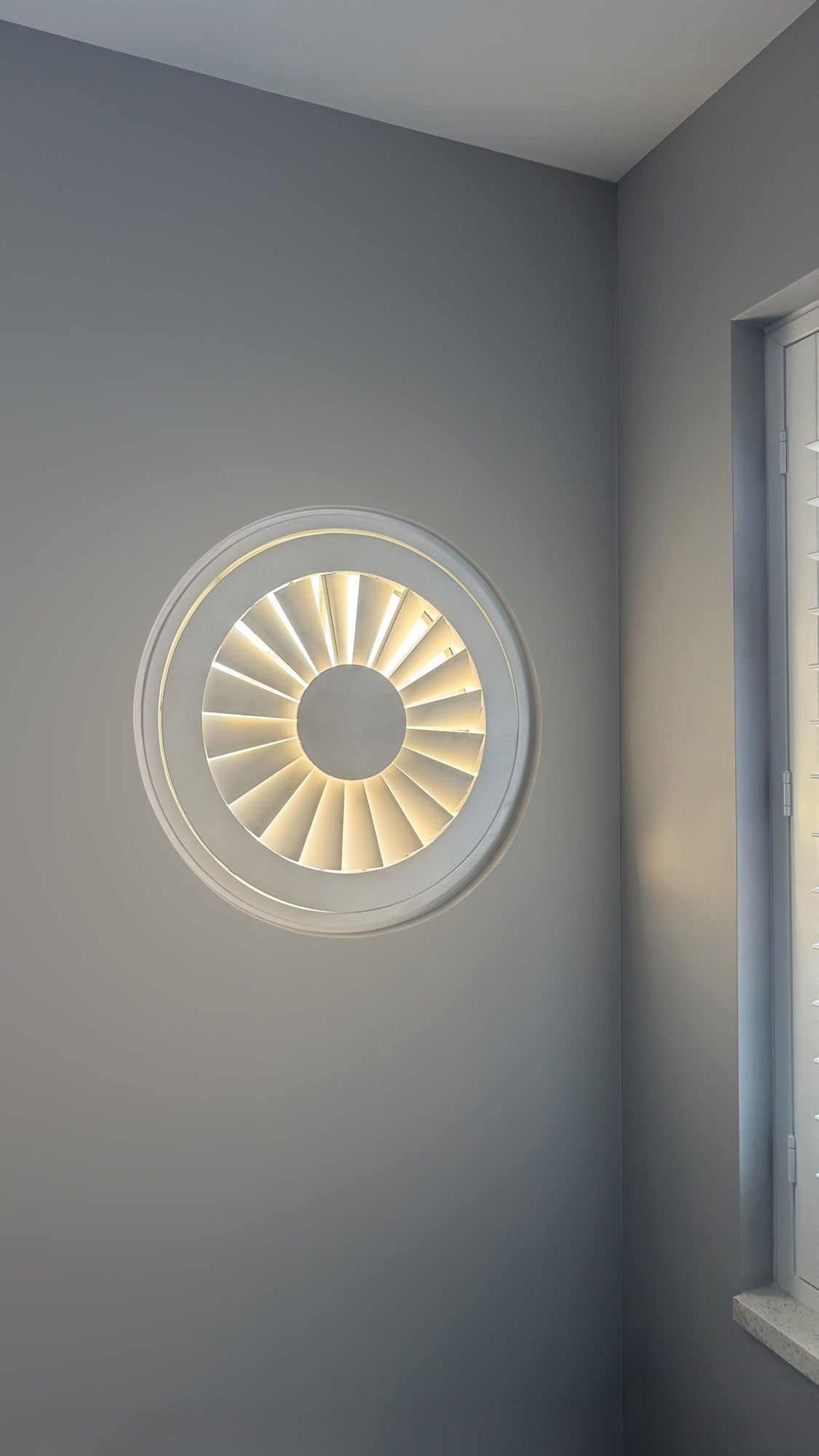 Special shape shutters on a round window, alternate view