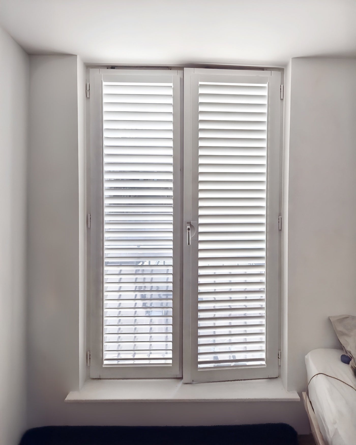 Tracked bi-fold shutters, folded open